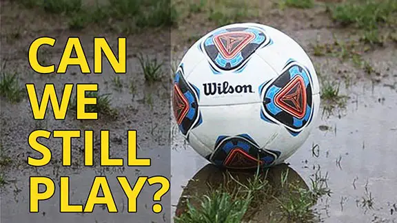 Soccer ball in rain puddle