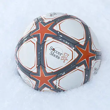 Soccer ball in winter snow