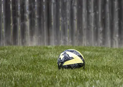 Wooden fence soccer ball