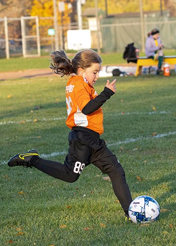Professional cameras not needed. Helpful guide with tips and tricks on How to Photograph Kids Soccer Games